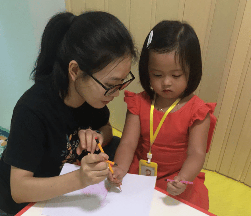 chinese teacher teaching a child